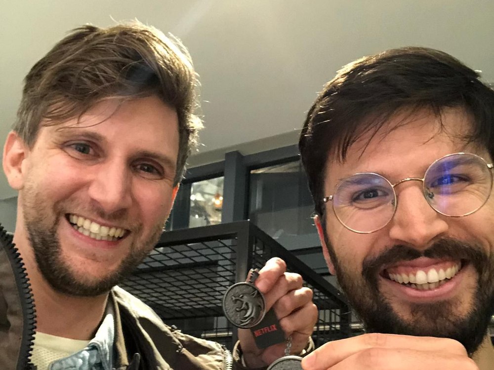 Alessandro with a friend holding The Witcher medallions